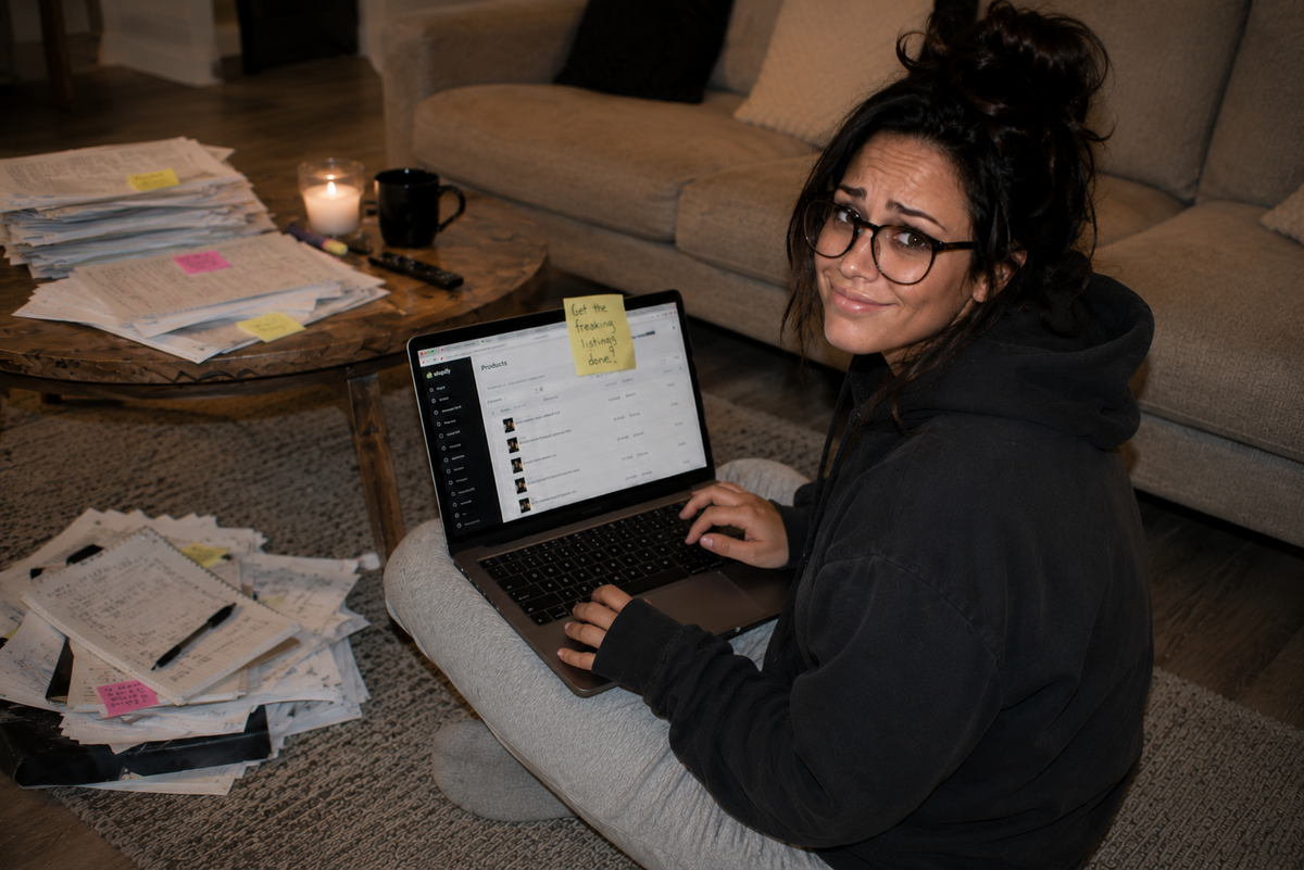 Founder holding a stack of unfinished product catalog materials
